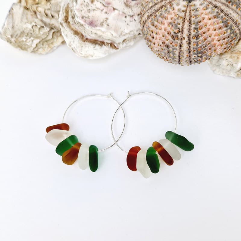 Kiawah Sea Glass Hoops presented on white background with sea shells as decoration