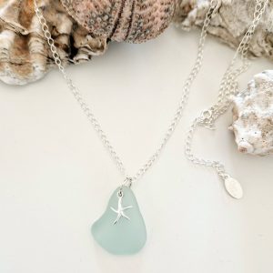 sea glass necklace showing among sea shells
