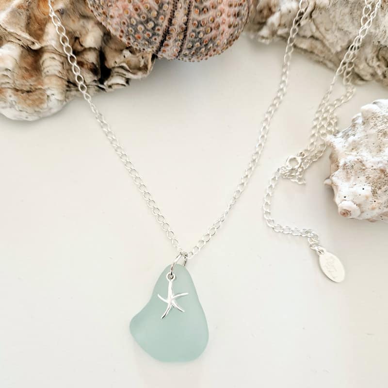 sea glass necklace showing among sea shells